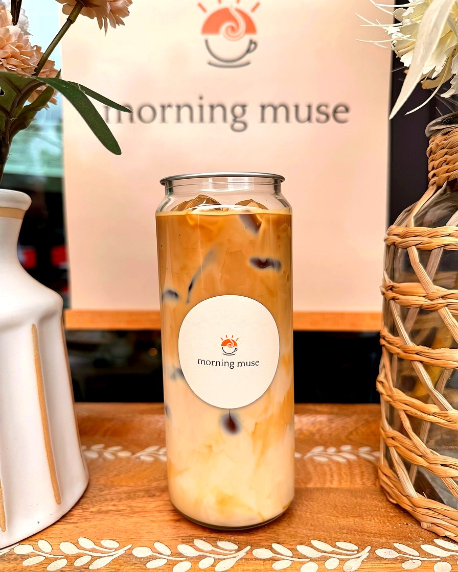 Vanilla bean latte in a Morning Muse can beside dried flowers