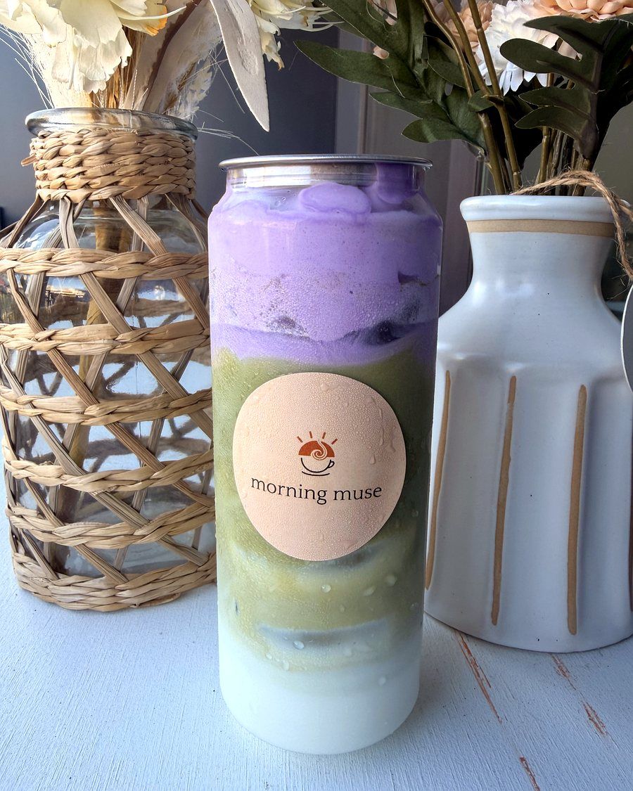 Ube Matcha can beside dried flowers and a rattan vase
